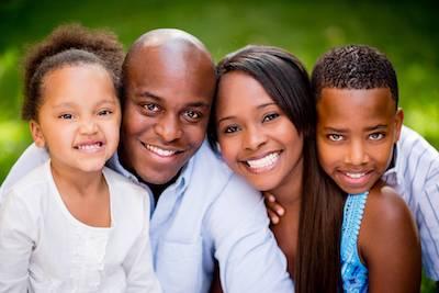 family of four smiling