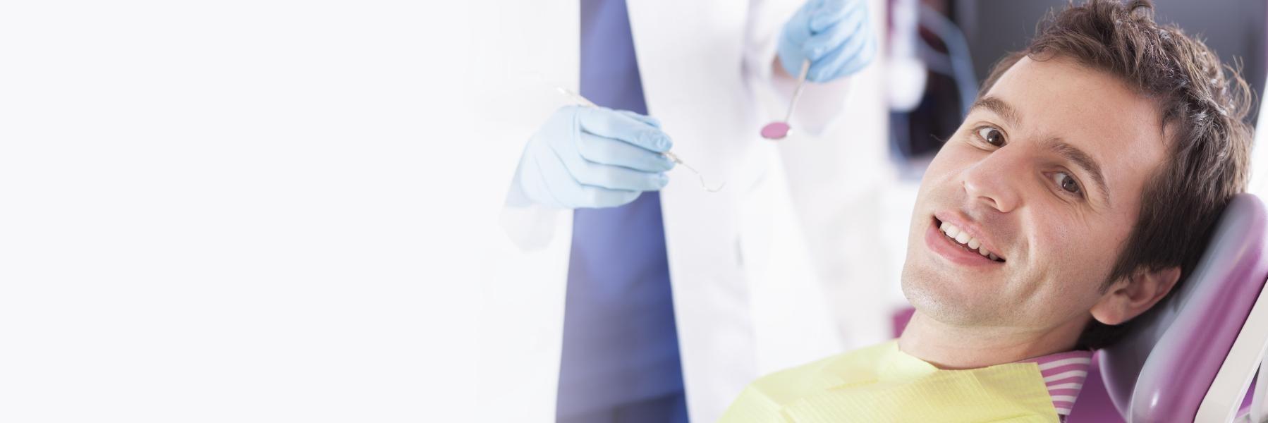 man sitting in dental chair