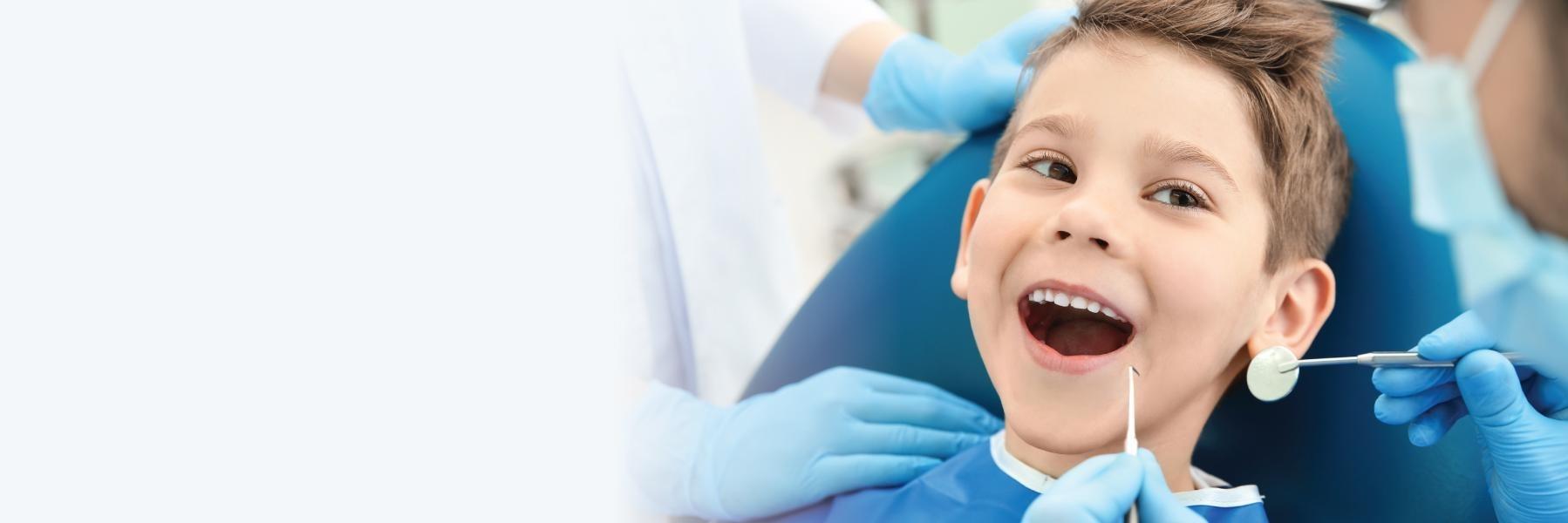 young boy sitting in dental chair